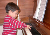A boy at the piano at Newton Music Academy