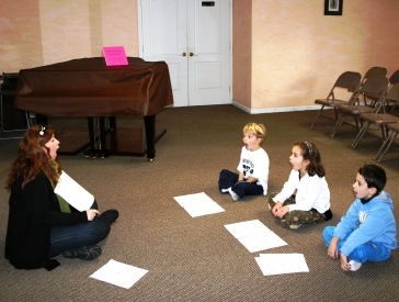 Children on a giant floor keyboard at Newton Music Academy